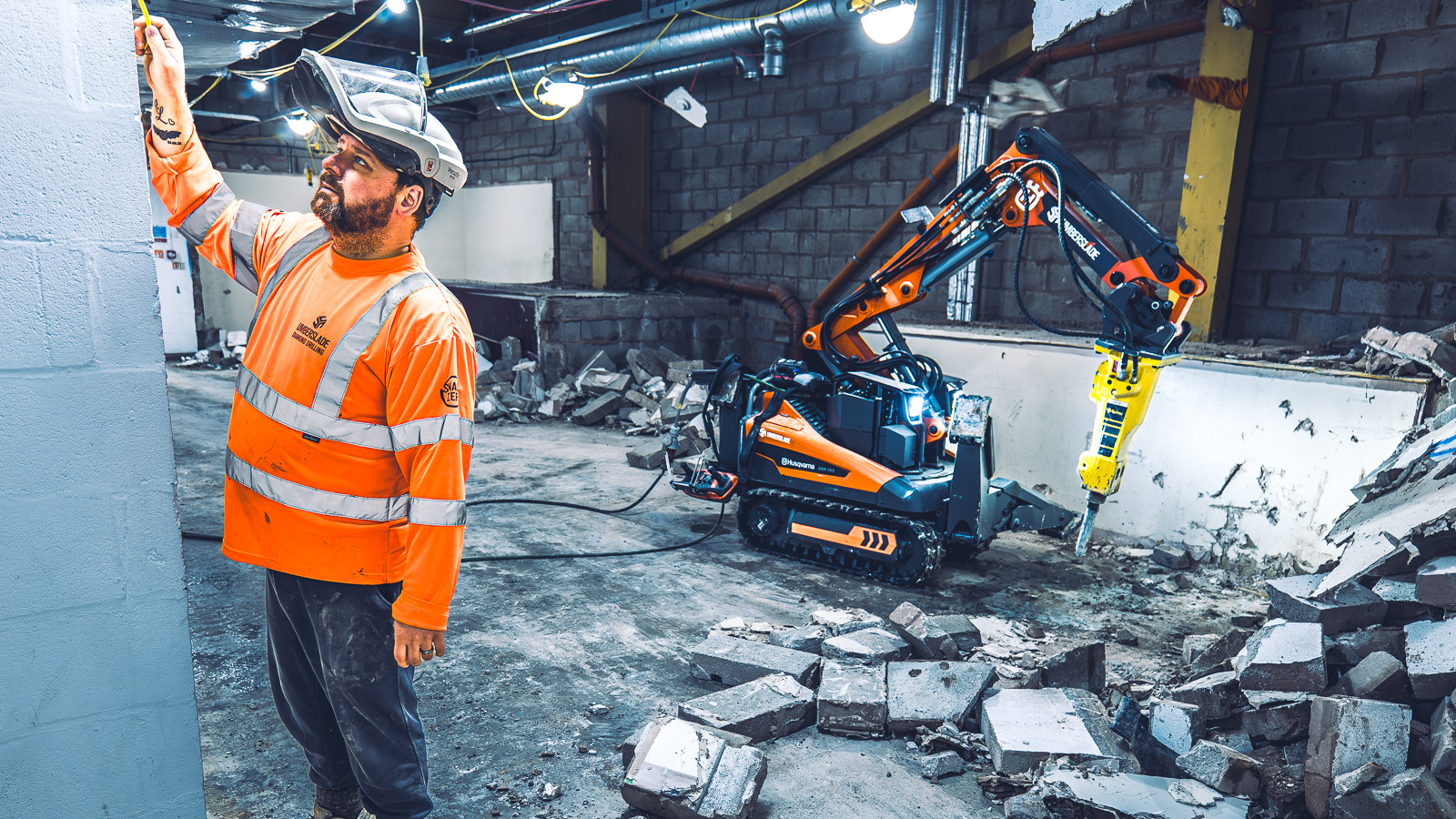 Umberslade team member and demolition equipment at work