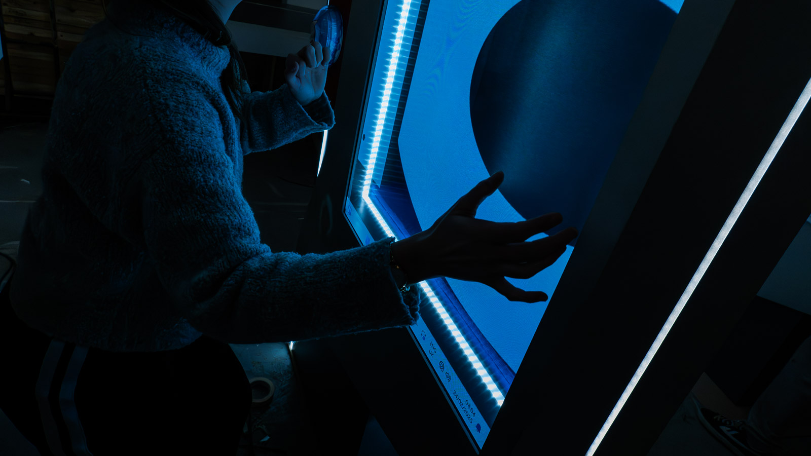 A team member checking an illuminated exhibition display