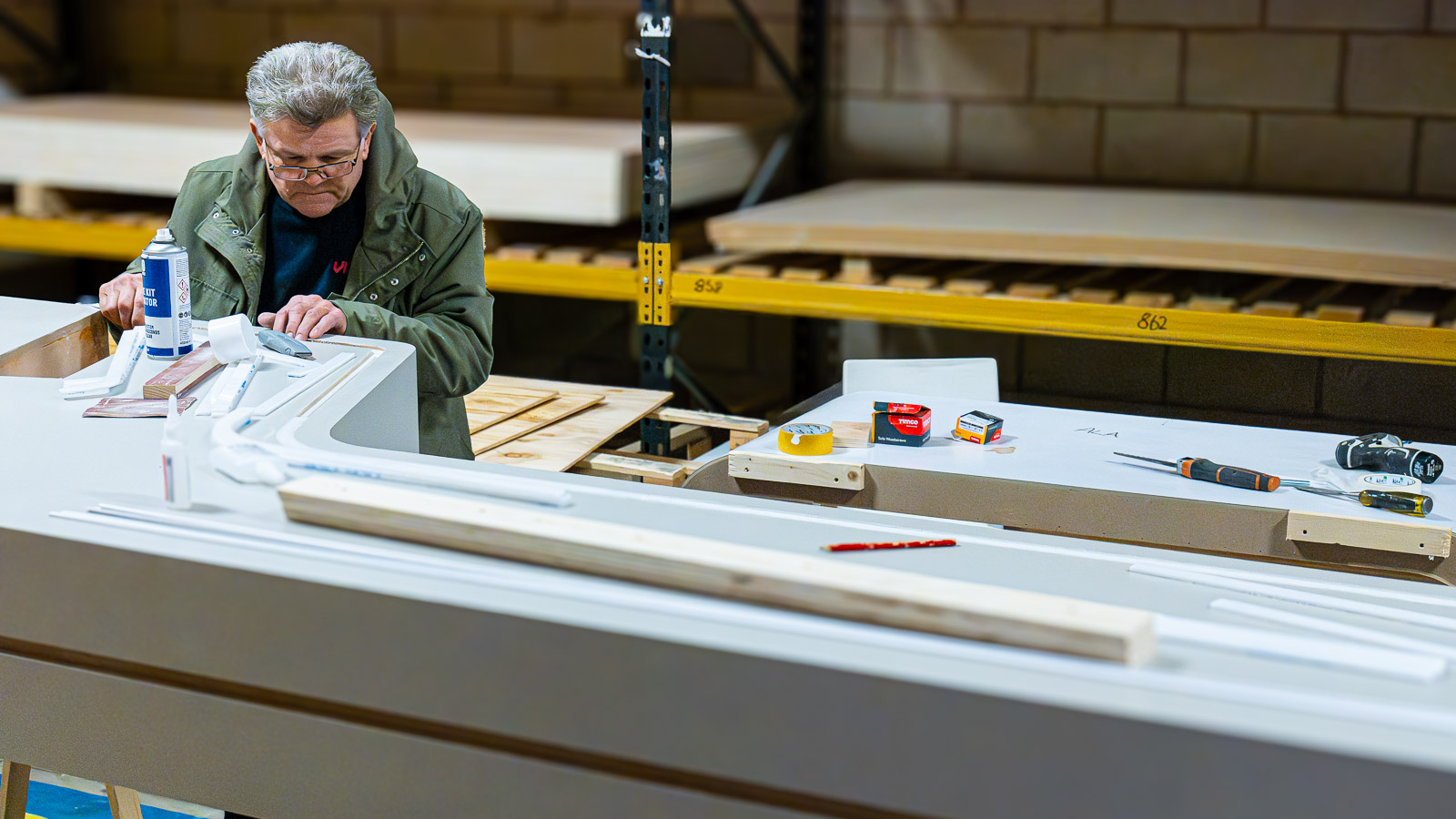 A Priority team member assembling exhibition components in the workshop