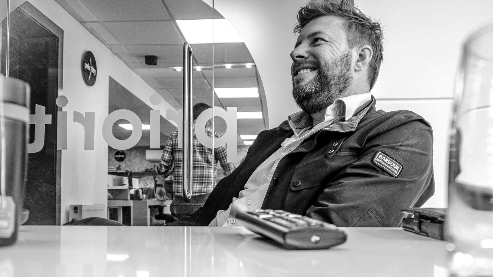 Black-and-white portrait photographed at Priority Exhibitions
