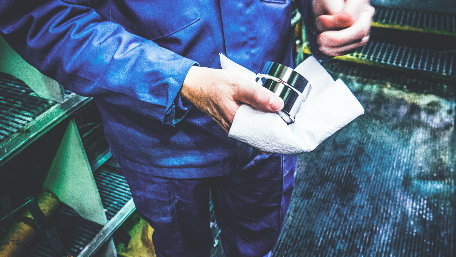 Anopol specialist handling and inspecting a metal component