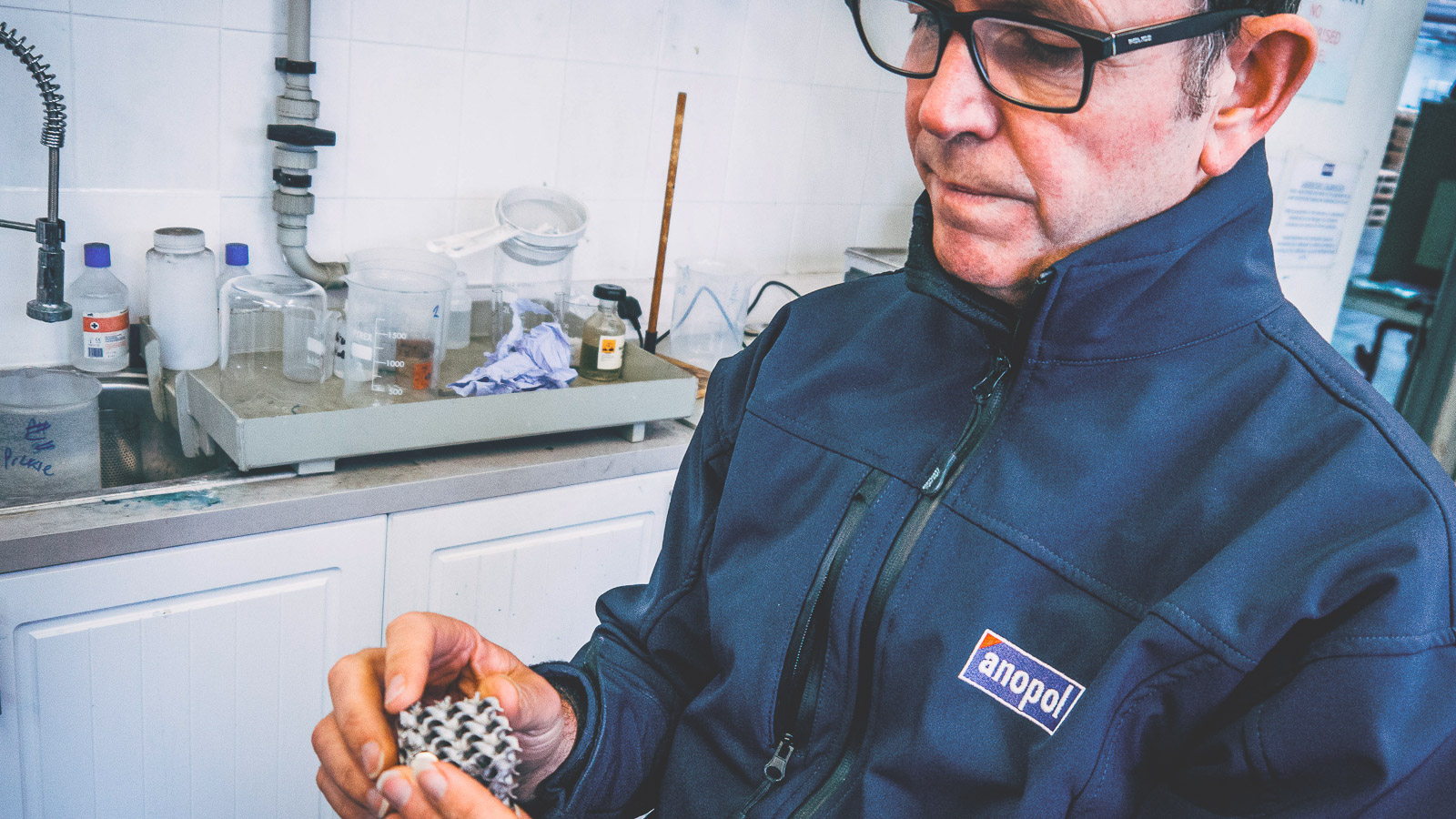 Anopol specialist examining a precision metal component